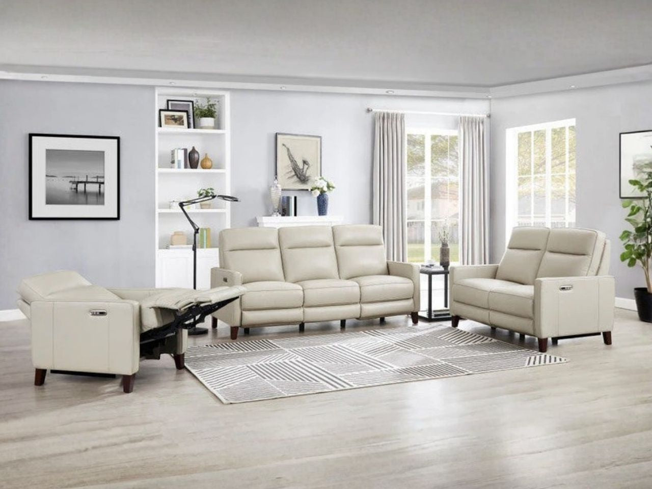 Cream leather reclining sofa and loveseat set in a bright living room.
