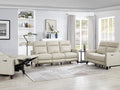 Matching beige leather recliner chairs arranged in a living room.
