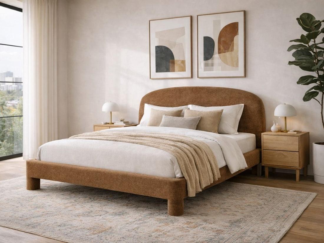 Brown upholstered bed with a rounded headboard styled in a modern bedroom with matching nightstands.