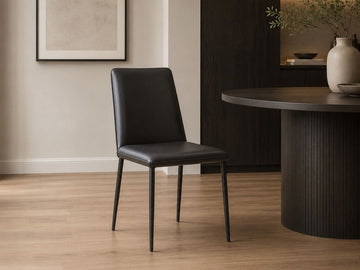 Nora Dining Chair in Black in a dining room setting. 
