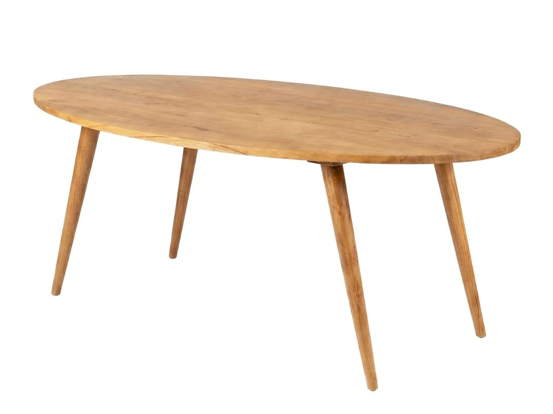 Oval wooden dining table styled with green chairs in a bright, modern dining room.