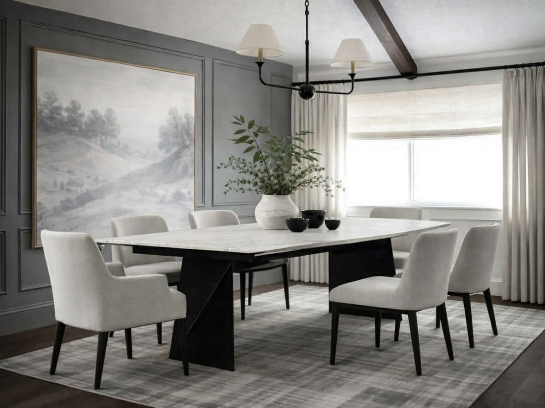Rectangular dining table with a light stone top and black sculptural legs, styled with brown leather dining chairs in a modern dining room.