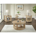 Light wood round coffee table with matching side tables styled in a bright, modern living room.