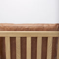 Close-up of Raeleigh Tan Faux Leather Accent Chair in Calgary with wooden frame