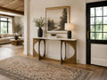 Marble-top console table styled in a bright modern entryway with neutral décor.