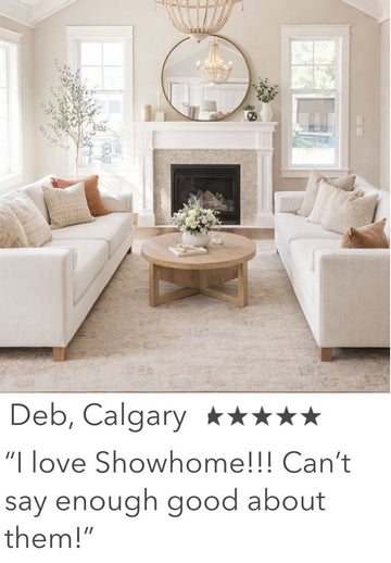 Living room with white sofas, a fireplace, and decorative elements.
