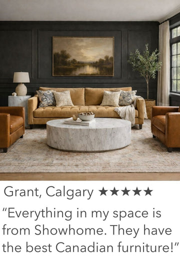 Living room with brown sofa, armchairs, and a round coffee table with decorative items.