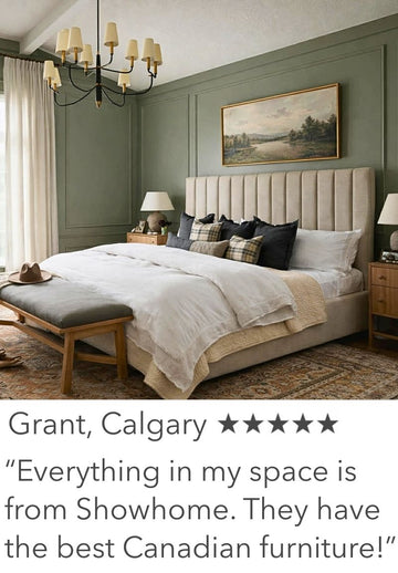 Neatly made bed in a bedroom with a chandelier and framed artwork on the wall.