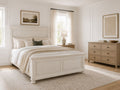 White panel bed with a storage footboard in a bright, modern farmhouse bedroom.