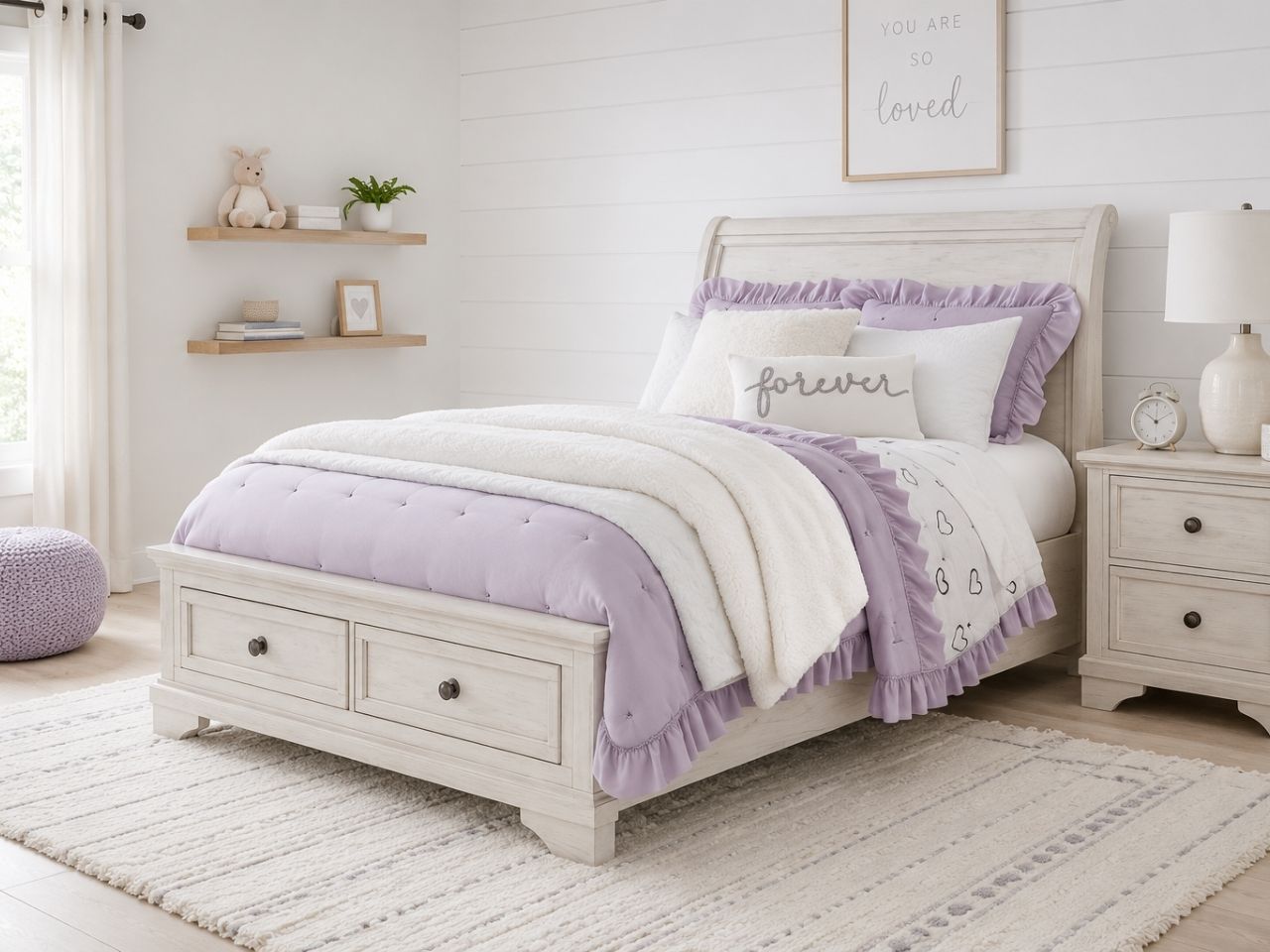 Whitewashed sleigh bed with built-in footboard storage drawers, perfect for a cozy kids' bedroom.