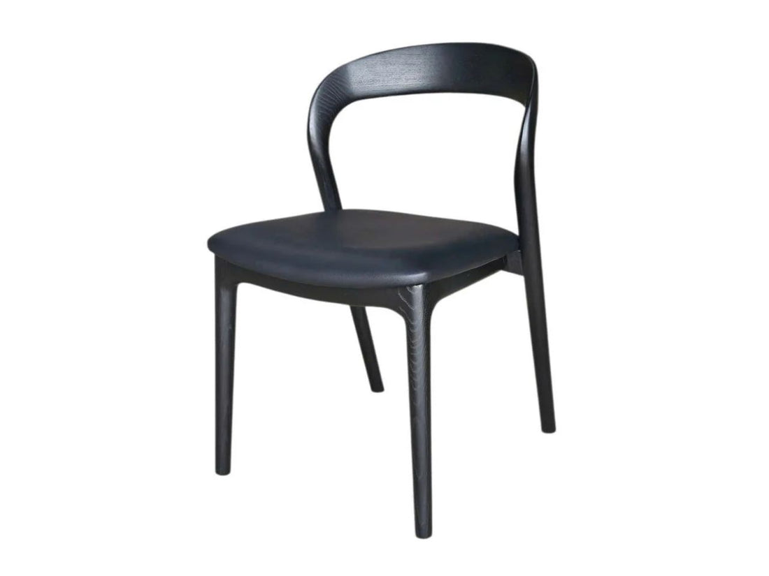 Black wooden dining chair with curved back on a white background.