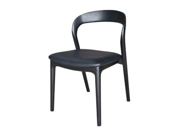 Black wooden dining chair with curved back on a white background.