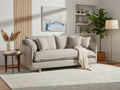 Light gray sofa styled in a bright modern living room with neutral decor.