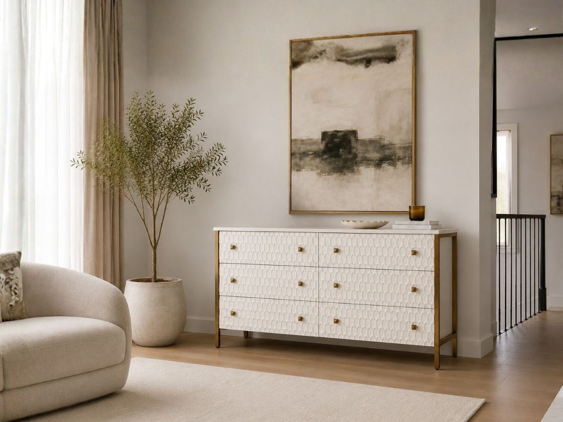 White textured sideboard with gold accents styled in a bright modern living room.