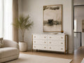 White textured sideboard with gold accents styled in a bright modern living room.