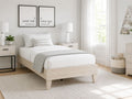 Light wood twin platform bed with a simple modern design.