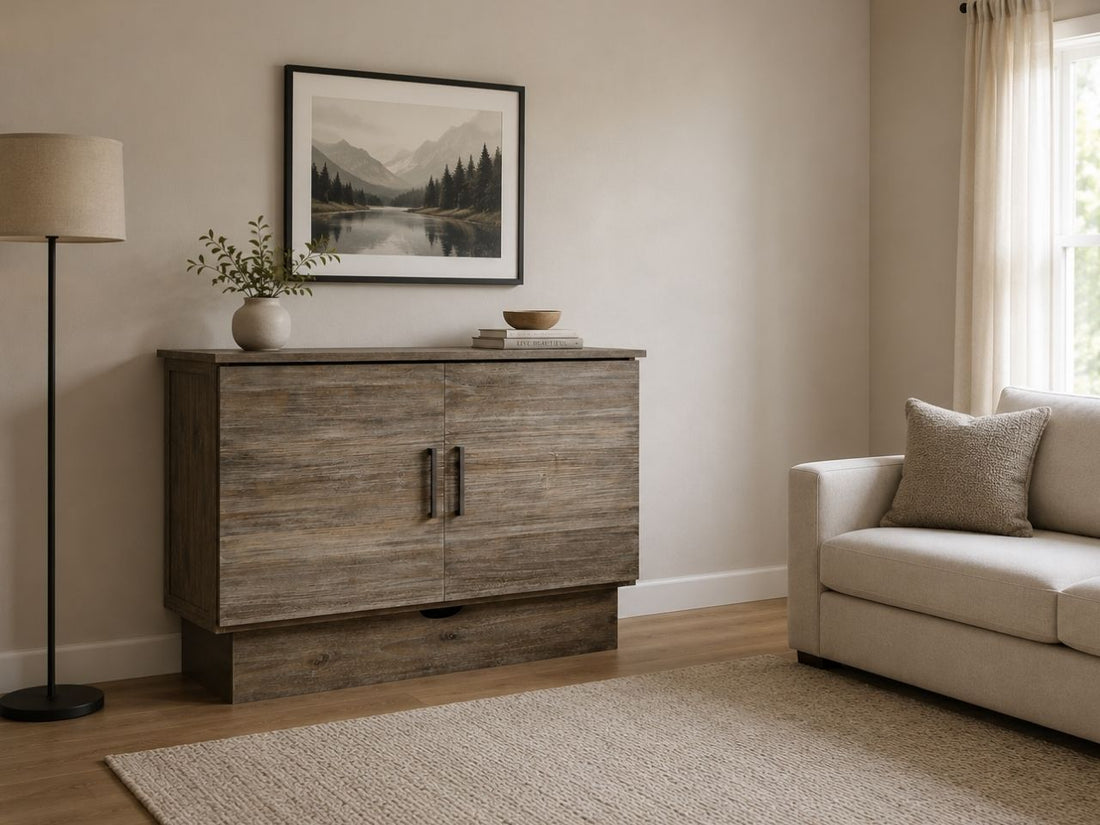 Rustic grey Murphy bed cabinet with weathered wood finish, modern black handles, and cozy neutral living room styling.