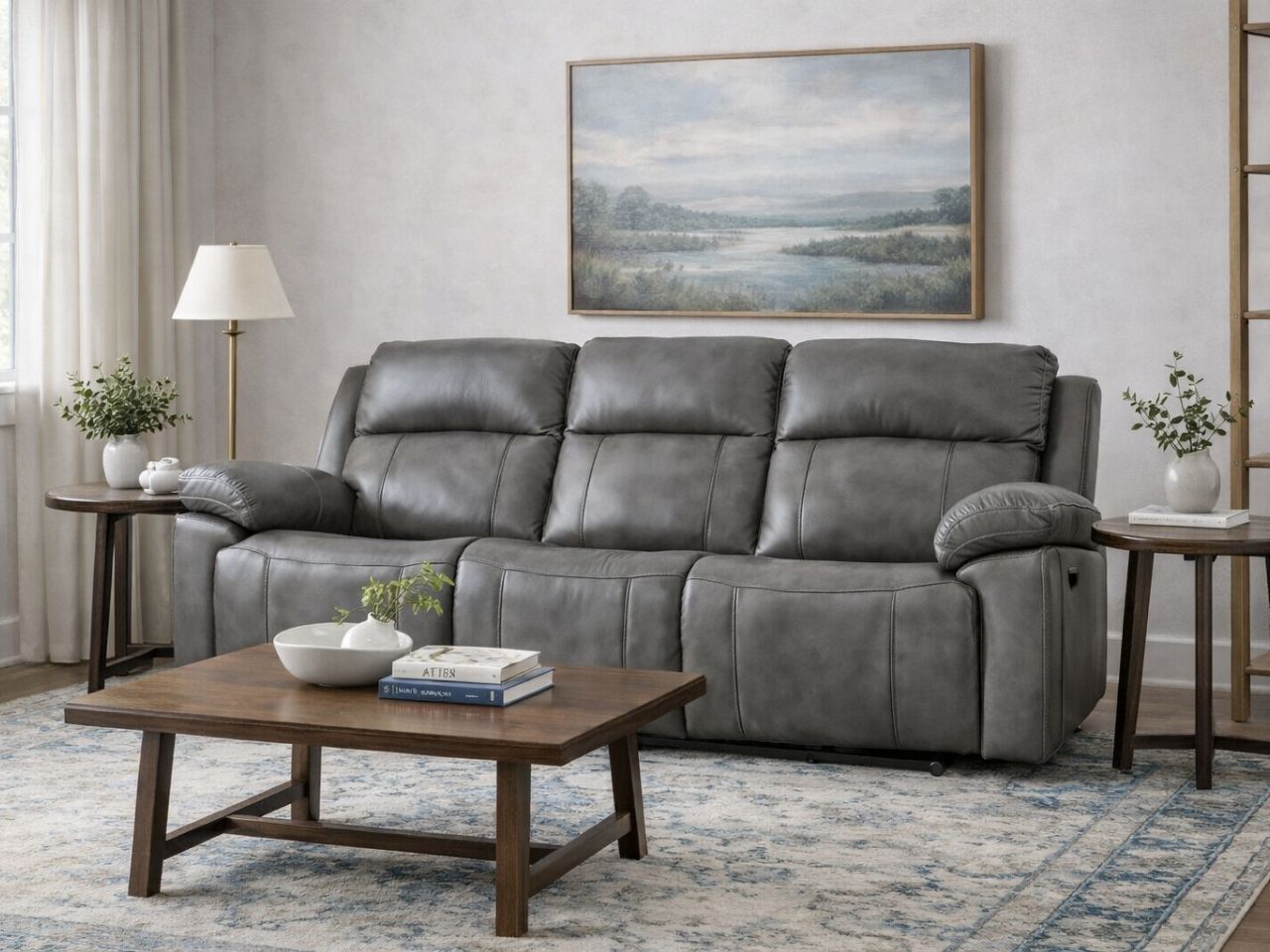 Gray leather reclining sofa styled in a modern living room.