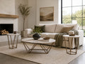 Round marble-top coffee table with two matching end tables and gold metal frames styled in a bright contemporary living room.