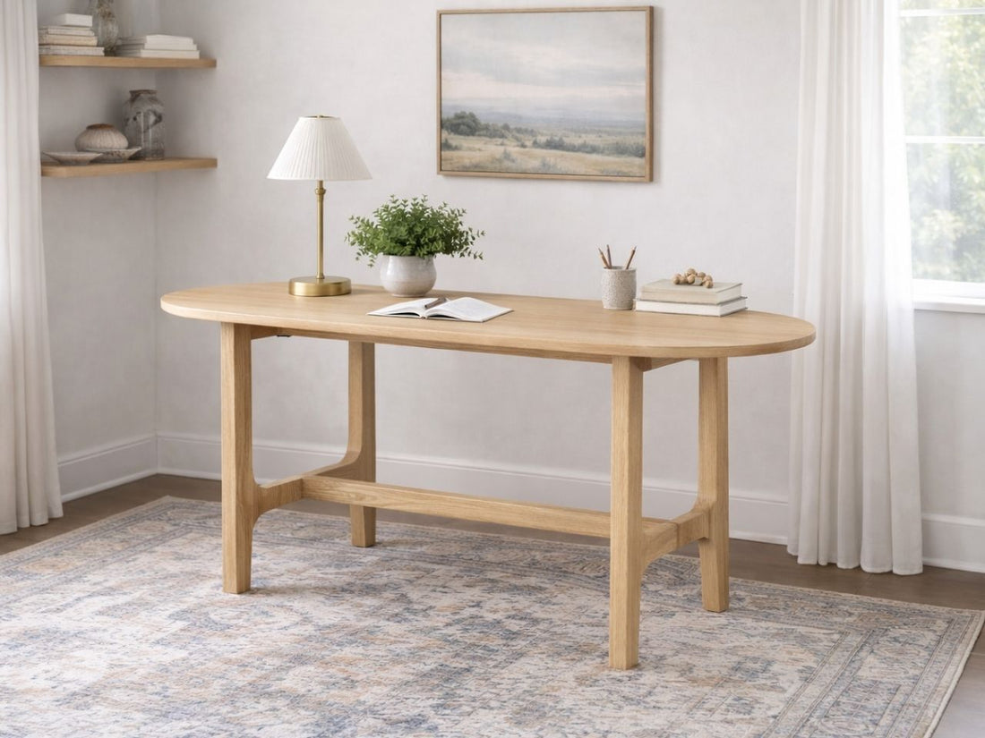 Light wood office desk with rounded edges in a bright home office.