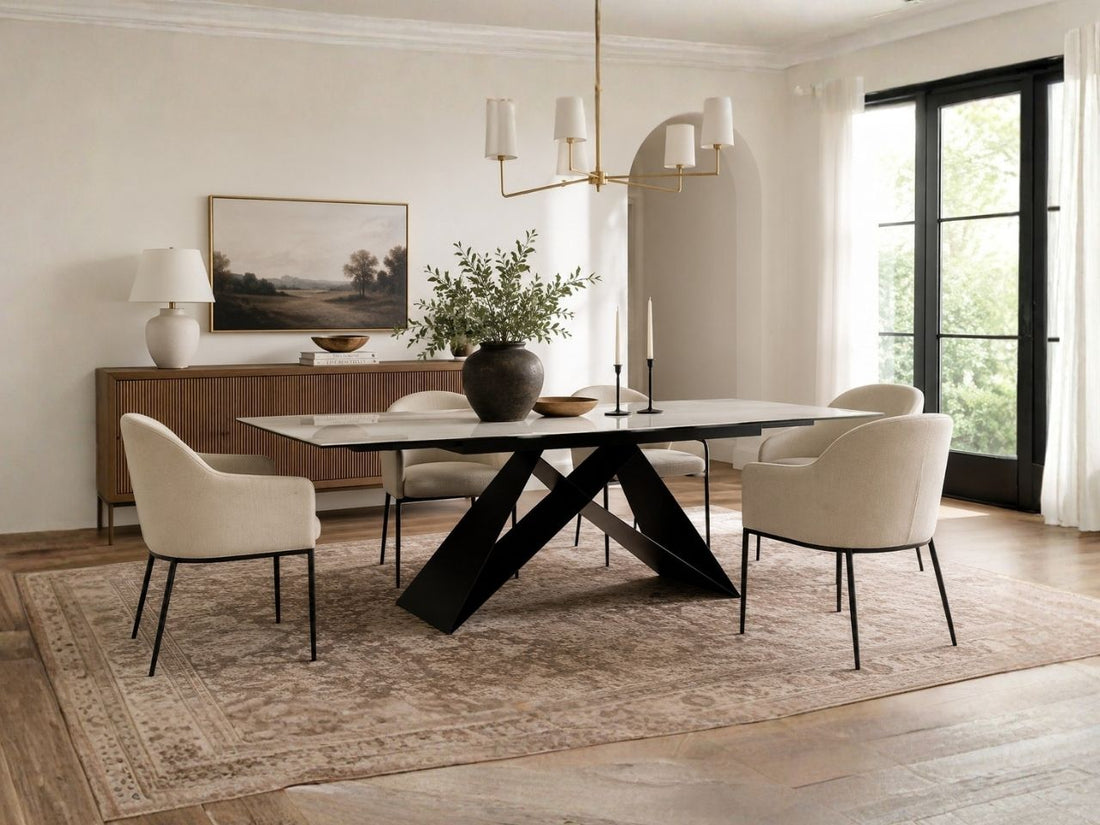 White extending dining table with four upholstered chairs.