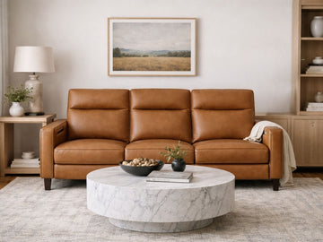 A brown leather sofa with clean lines in a cozy, contemporary living room.