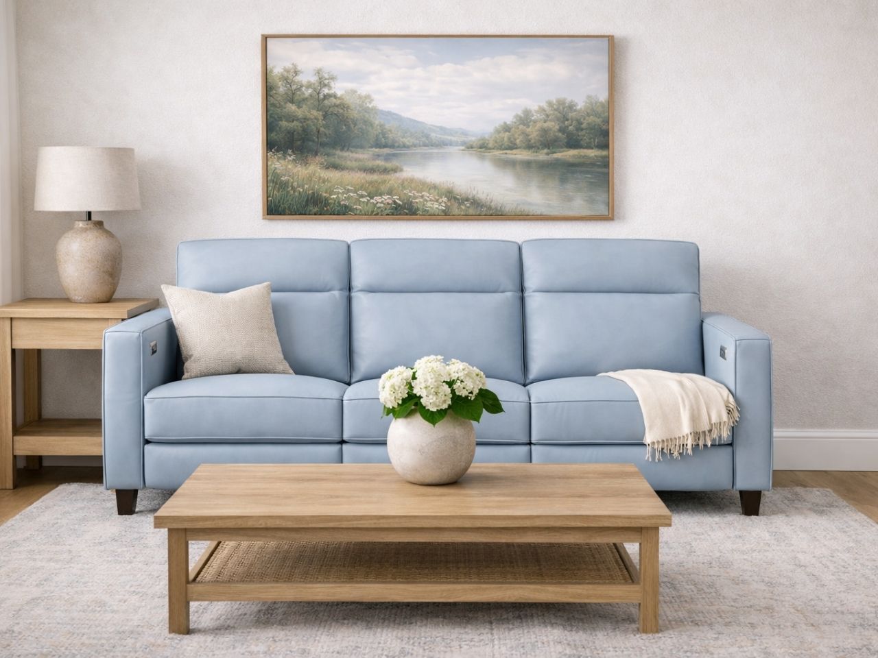 A light blue upholstered sofa in a calm, neutral living room.