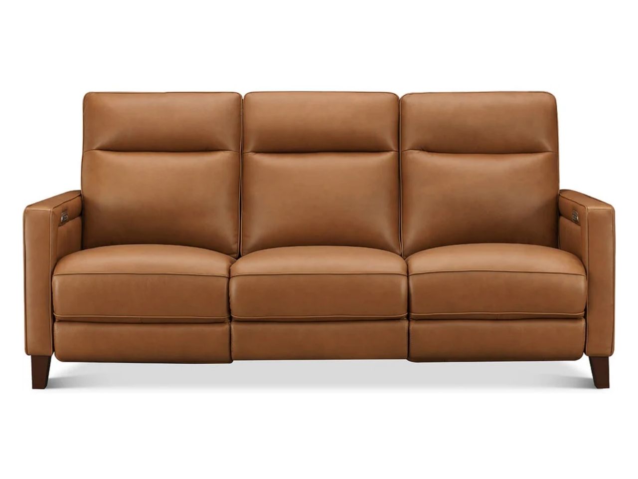 Tan leather sofa featuring three plush seat cushions, supportive high backs, wide armrests with subtle detailing, and dark wooden legs, front view on a white background.