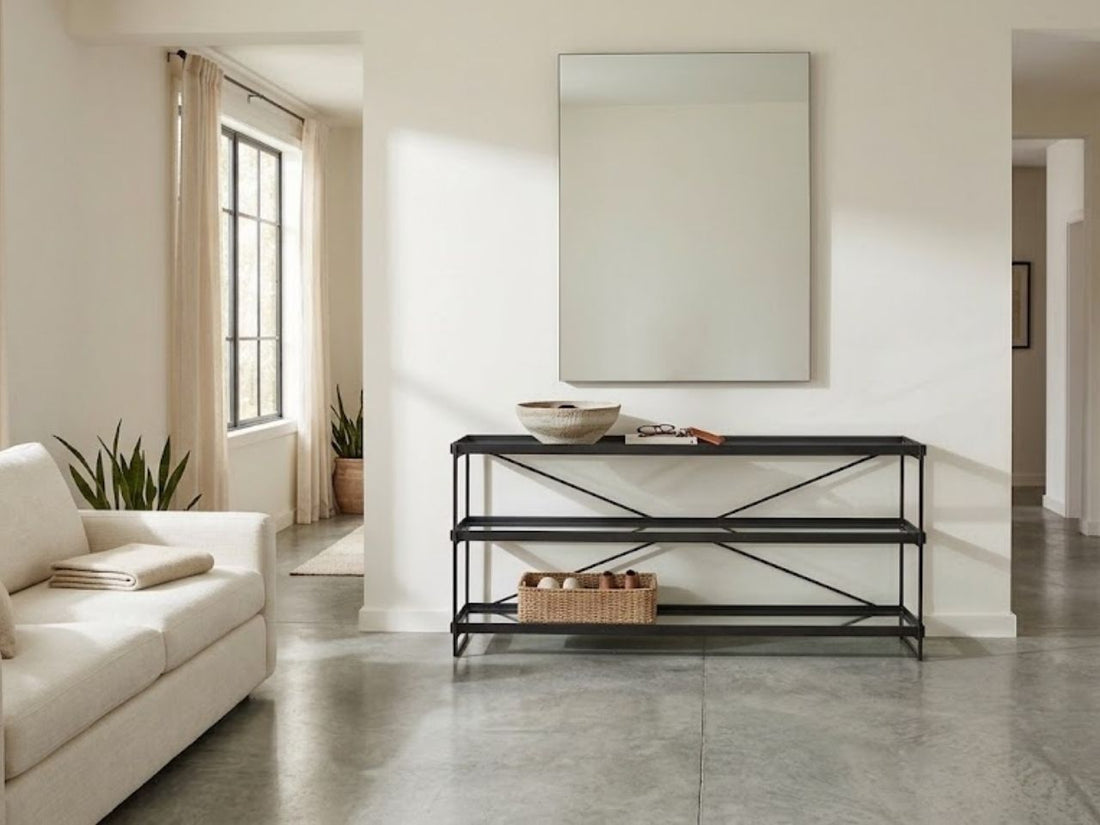 Black metal console table with open shelves styled in a modern living room.