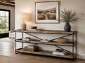 Brown wood and metal console table styled in a modern living room with neutral décor and open shelves.