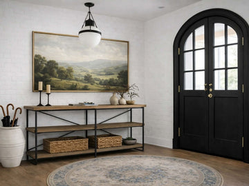 A three-tier industrial-style console table with light-brown wooden shelves and a black metal frame.