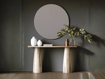 A minimalist, light wood console table featuring two thick, tapered sculptural pedestal legs and a slim rectangular top.