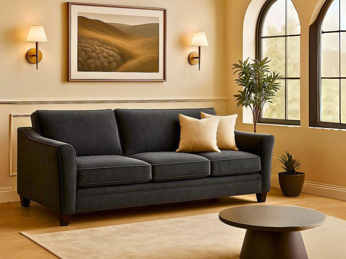 Custom Tyson sofa in a living room with a painting, lamp, and window.