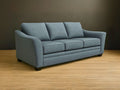 Custom Tyson sofa on a wooden floor with a dark brown wall background