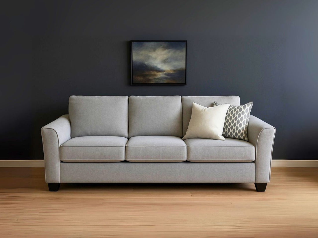 Custom Tyson sofa in a living room with a painting, lamp, and window.