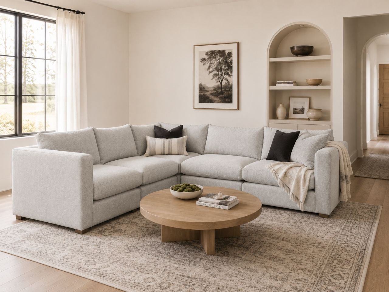 Light gray modular sectional in a bright modern living room.