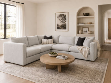 Light gray modular sectional in a bright modern living room.