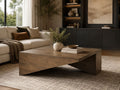 Modern wood coffee table with an angled base, styled in a contemporary living room.