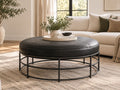 Round black leather ottoman with stitched detailing and an open black metal frame.