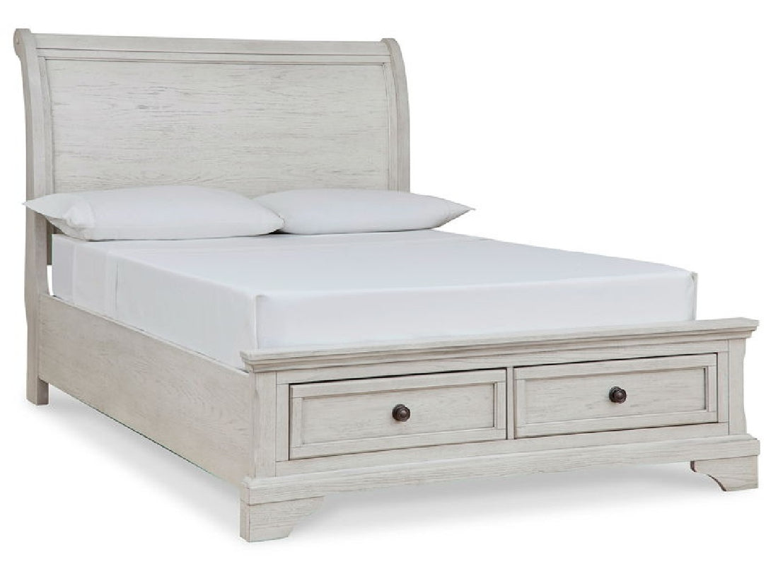 Whitewashed sleigh bed with built-in footboard storage drawers, perfect for a cozy kids' bedroom.